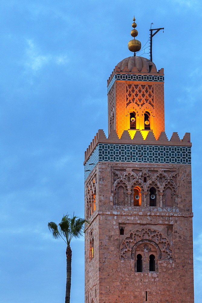 The Minaret of the Koutoubia Mosque, illuminated at dusk with single palm tree, UNESCO World Heritage Site, Marrakech, Morocco, North Africa, Africa