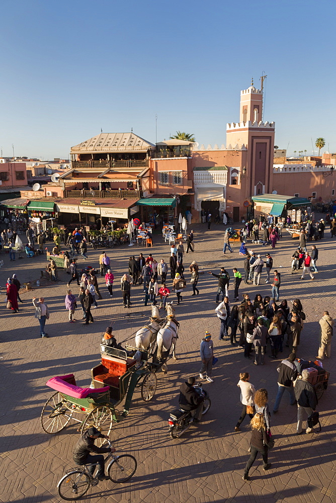 Long shadows in the busy square of Place Jemaa el-Fna, UNESCO World Heritage Site, Marrakech, Morocco, North Africa, Africa