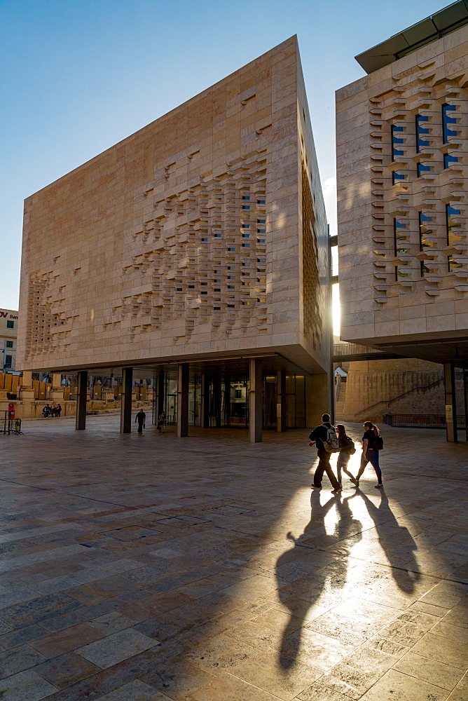 People walking past Parliament House on Freedom Square in Valletta, Malta, Europe