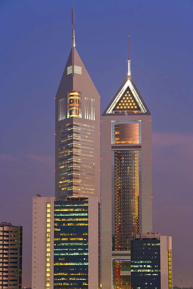 Emirates Towers on Sheikh Zayed Road illuminated at dusk, Dubai, United Arab Emirates, Middle East