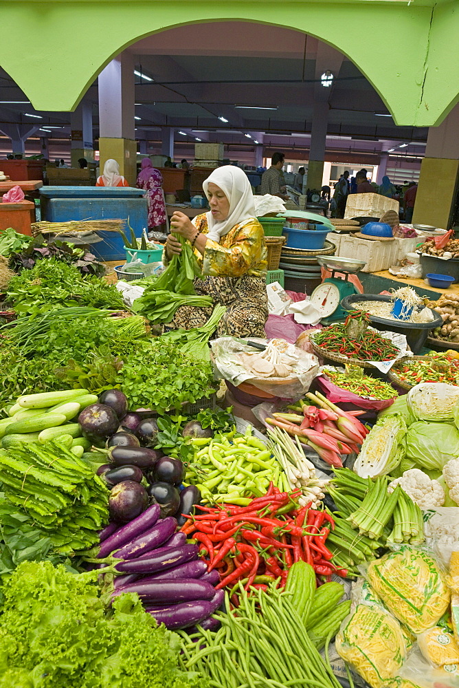 Women selling fruit and vegetables in the town's central market, Kota Bharu, Kelantan State, Malaysia, Southeast Asia, Asia 