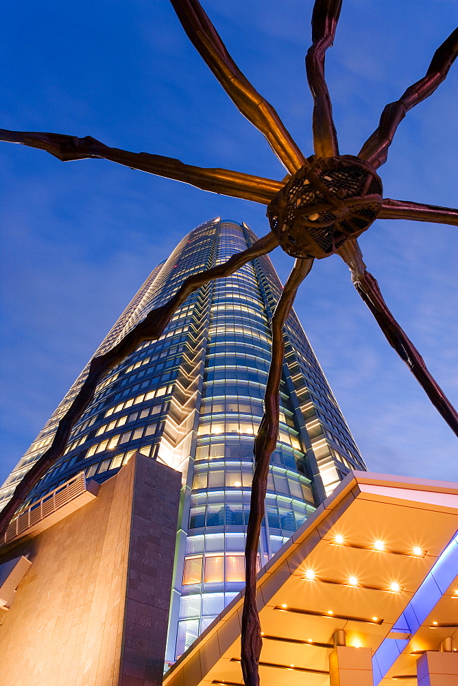 Low angle view at dusk of Mori Tower and Maman Spider sculpture, Roppongi Hills, Minato Wad, Tokyo, Honshu, Japan, Asia 