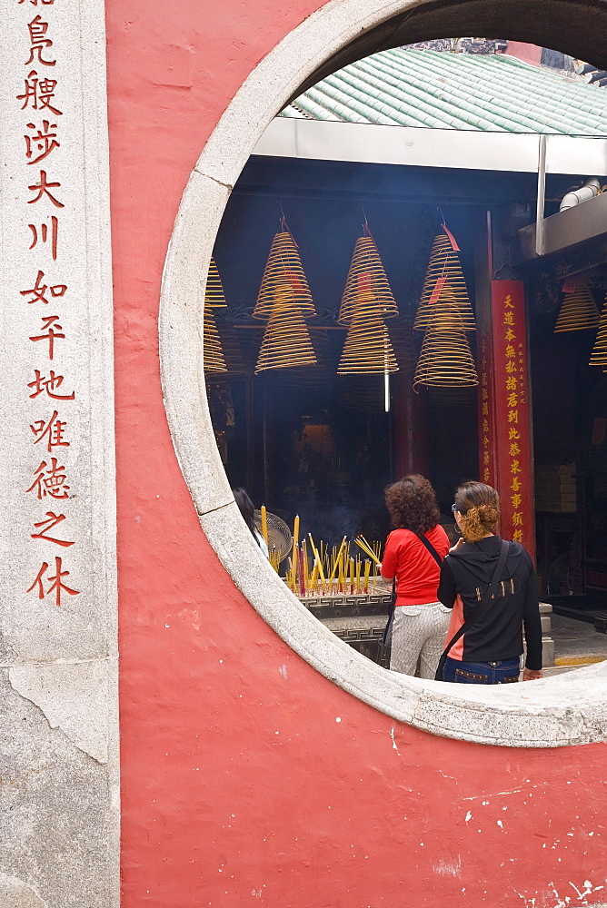 The A Ma Temple, incense hangs from the ceiling as worshippers pray and make offerings, Macau, China, Asia