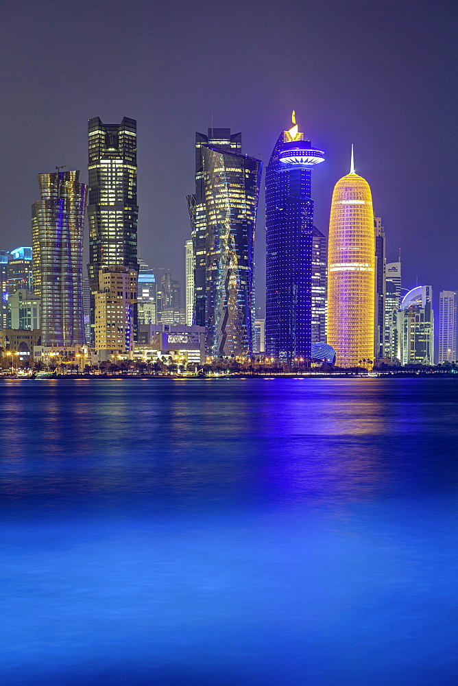 New skyline of the West Bay central financial district of Doha, illuminated at dusk, Doha, Qatar, Middle East