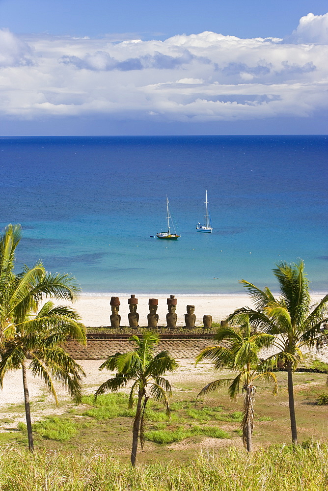 Anakena beach, yachts moored in front of the monolithic giant stone Moai statues of Ahu Nau Nau, four of which have topknots, Rapa Nui (Easter Island), UNESCO World Heritage Site, Chile, South America