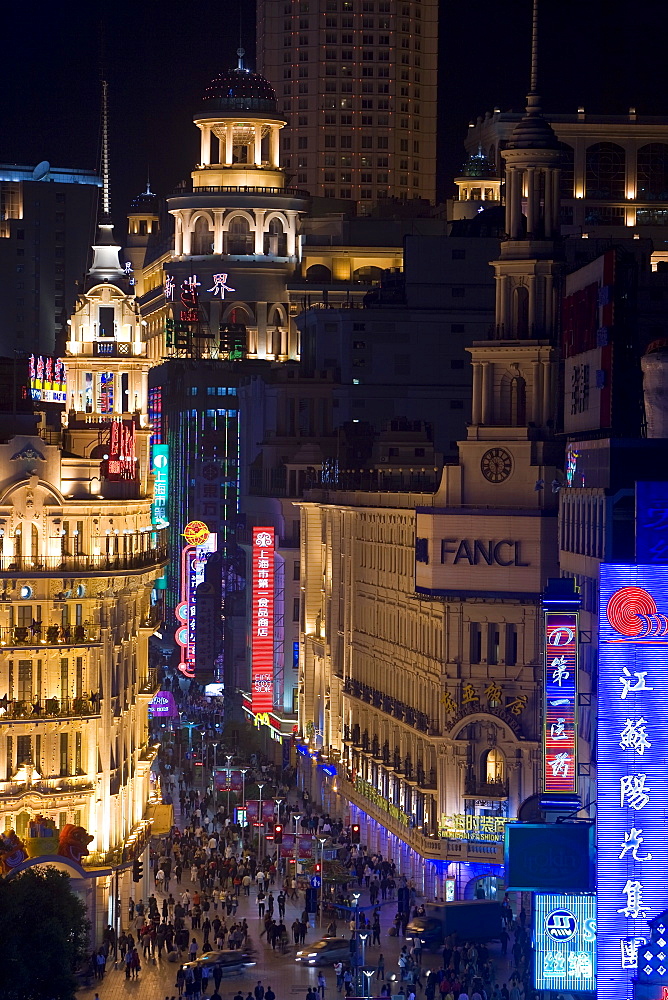 Elevated view along Nanjing Donglu Road illuminated with neon signs at night, Shanghai, China, Asia