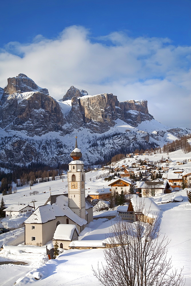 The church and village of Colfosco in Badia, 1645m, and Sella Massif range of mountains under winter snow, Dolomites, South Tirol, Trentino-Alto Adige, Italy, Europe