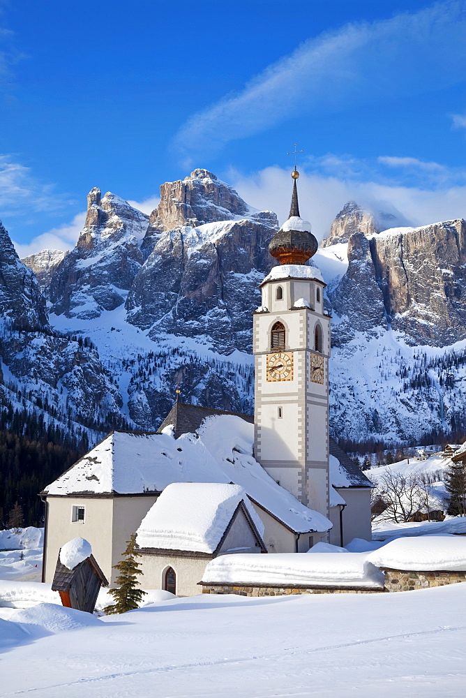 The church and village of Colfosco in Badia, 1645m, and Sella Massif range of mountains under winter snow, Dolomites, South Tirol, Trentino-Alto Adige, Italy, Europe