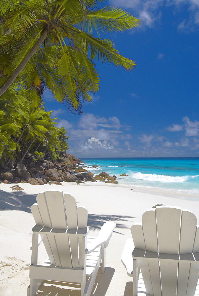 Two Adirondack chairs on tropical beach, Seychelles, Indian Ocean, Africa