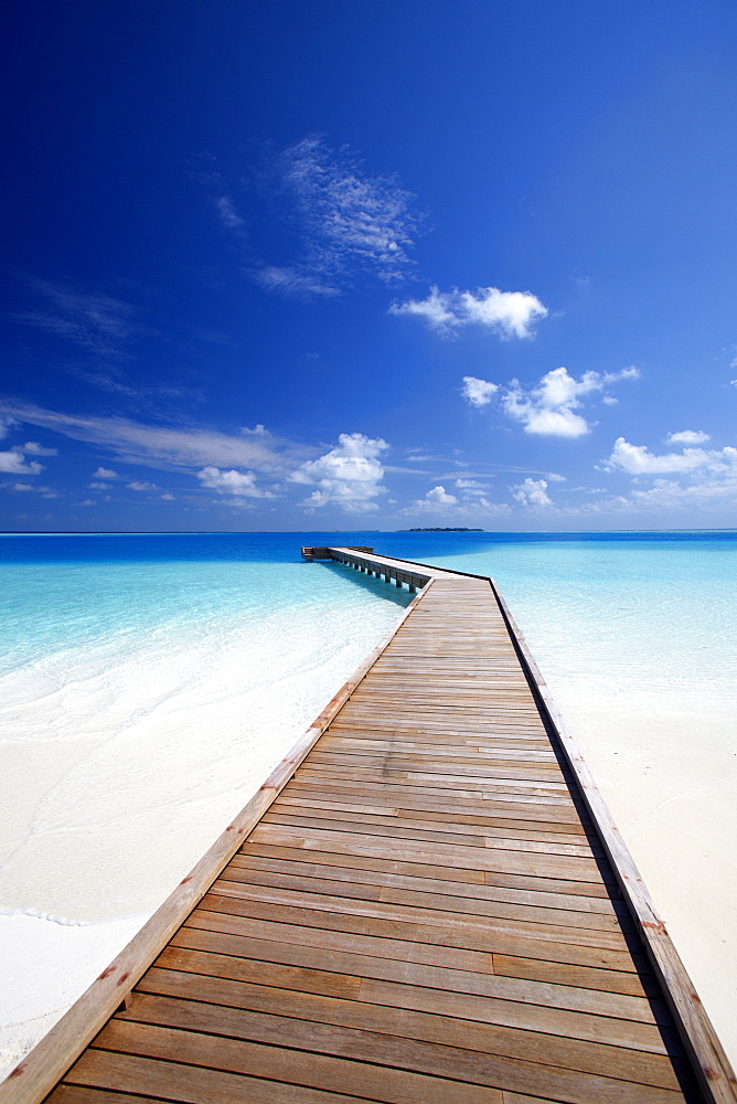 Wooden jetty out to tropical sea, Maldives, Indian Ocean, Asia