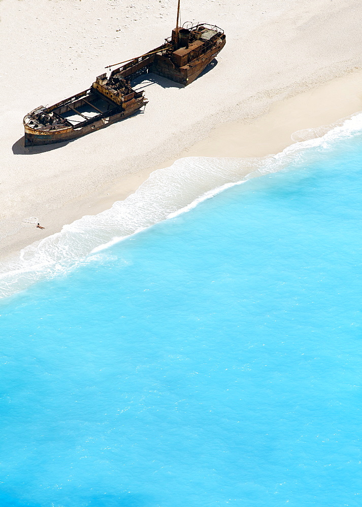 Woman drawing a heart on Zakynthos Beach near wrecked ship, Zakynthos, Greek Islands, Greece, Europe