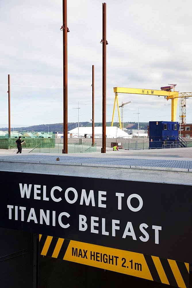 Ireland, North, Belfast, Titanic Quarter, Visitor centre carpark entrance welcome sign, with a Harland & Wolff yellow crane behind.