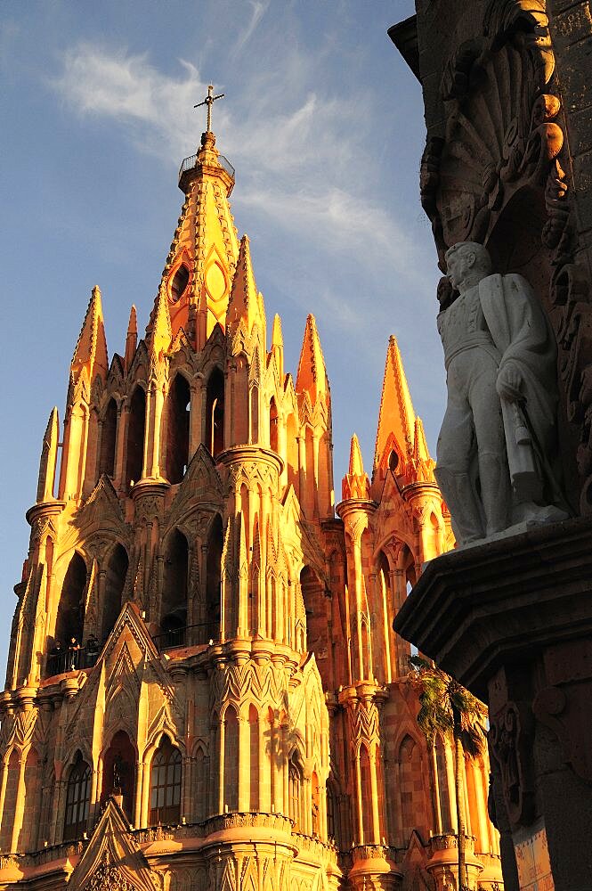 Mexico, Bajio, San Miguel de Allende, La Parroquia de San Miguel Arcangel neo-gothic exterior with statue of Ignacio Allende in foreground.