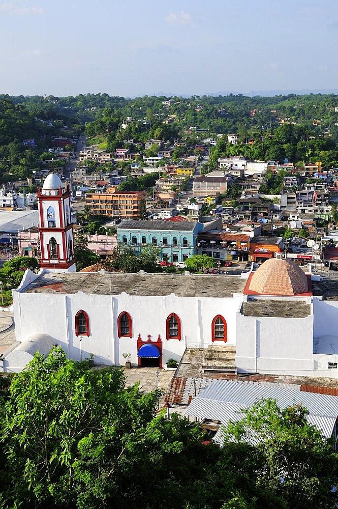 Mexico, Veracruz, Papantla, Views over Cathedral Zocalo and surrounding buildings set amongst trees.