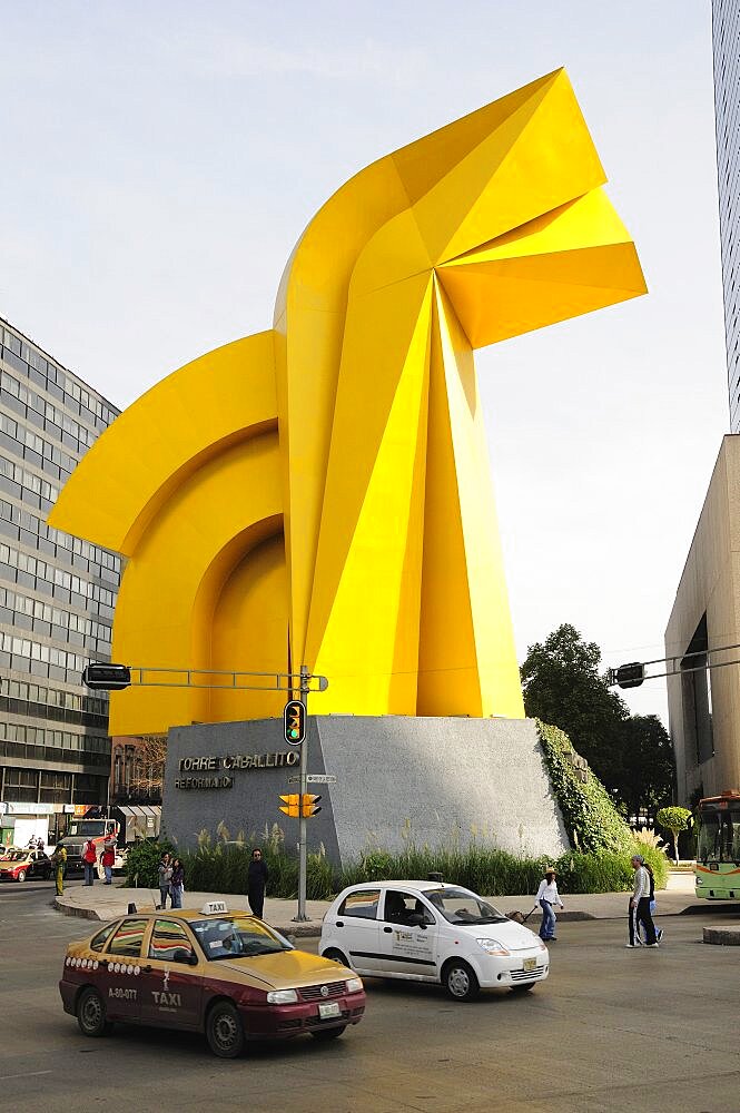 Mexico, Federal District, Mexico City, Traffic passing Little Horse sculpture of Torre Caballito on Reforma.