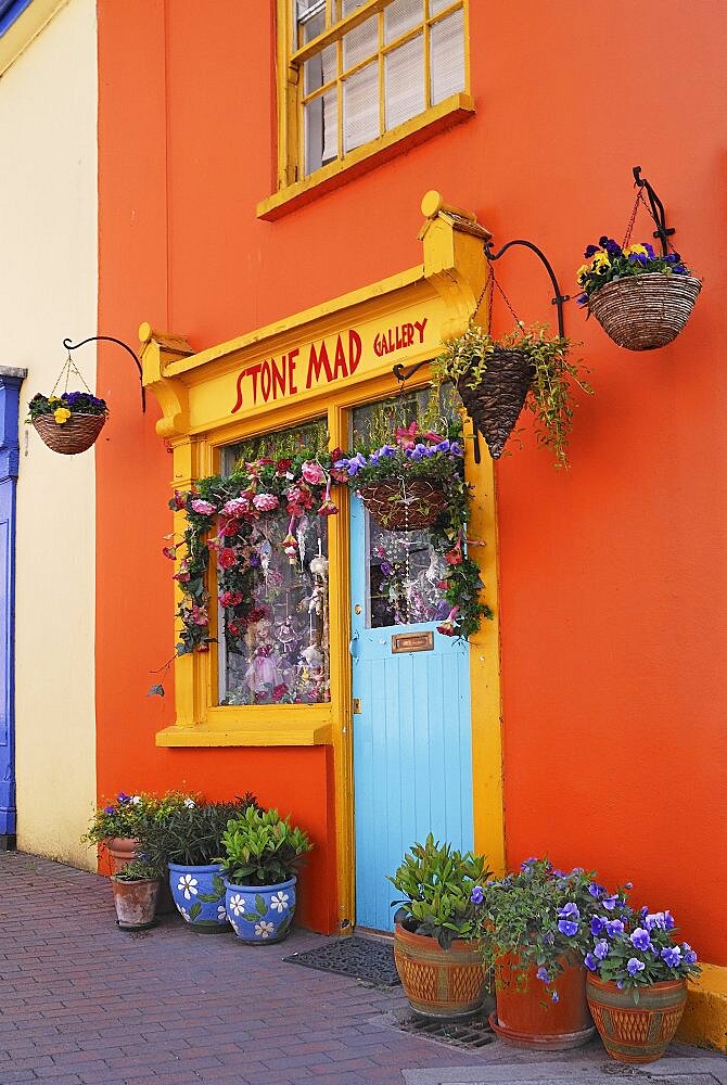 Ireland, County Cork, Kinsale, Colourful facade in market place with flower pots.