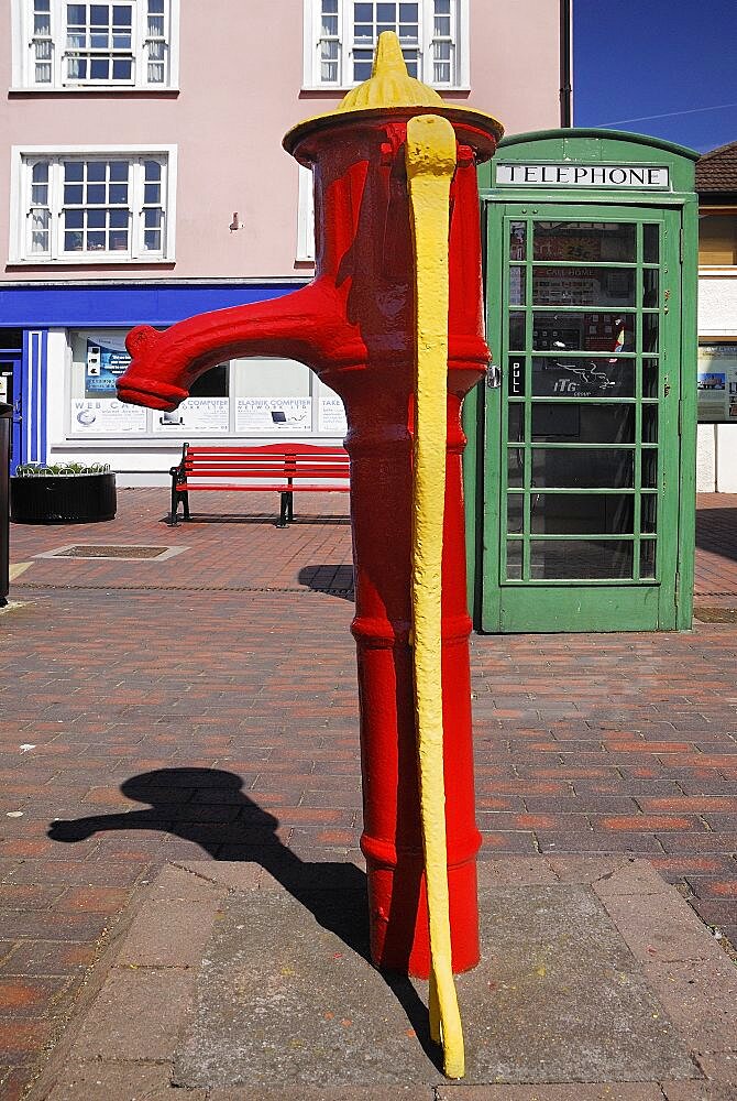 Ireland, County Cork, Kinsale, Colourful old water pump and telephone box .