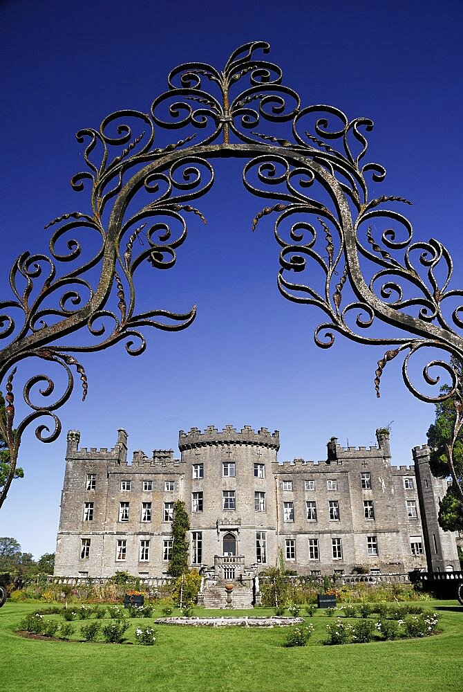 Ireland, County Sligo, Markree, Castle hotel castle and garden viewed through ornamental iron grille.