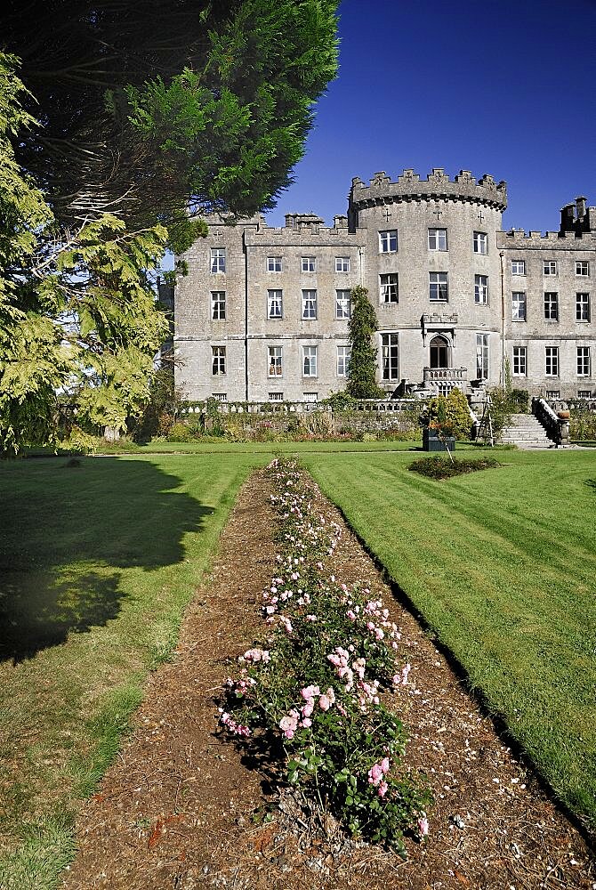 Ireland, County Sligo, Markree, Castle hotel view of a section of the castle with row of flowers in the foreground.