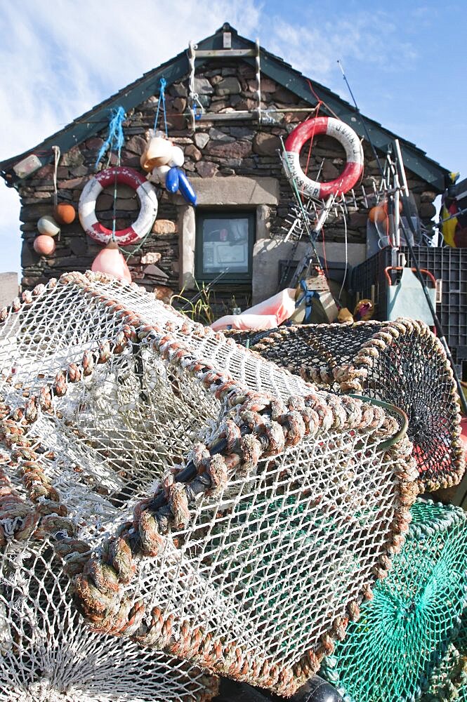 Scotland, Firth of Lorn, Isle of Easdale, Lobster pots outside a fishermans house on one the slate islands.