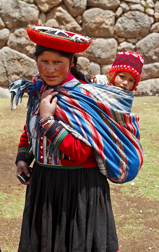 Peru, Indigenous People, Woman with baby in traditional dress.