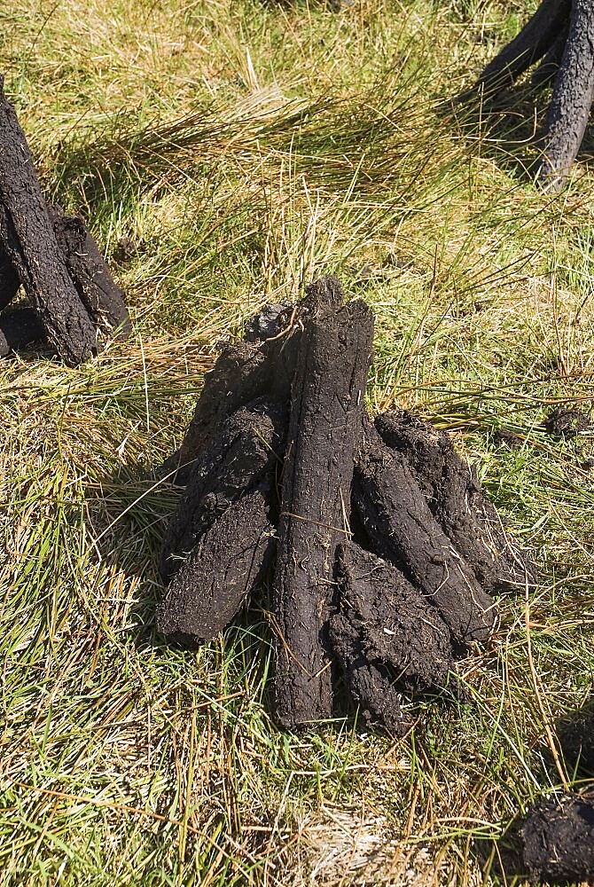 Ireland, County Sligo, Sligo, Peat stacks below Ben Wisken Mountain.