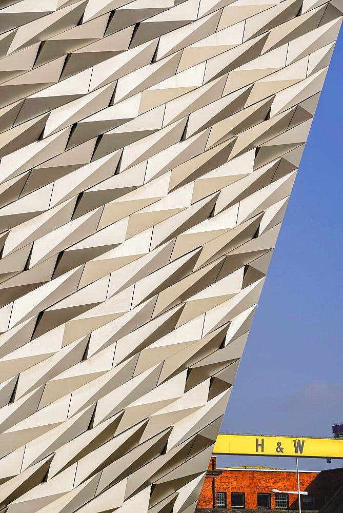 Ireland, North, Belfast, Titanic Quarter, Titanic Belfast Visitor Experience, Section of building with yellow Harland & Wolff crane.