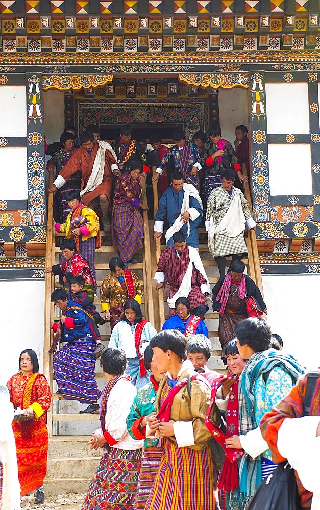 Bhutan, Gangtey Gompa, Tsecchu festival crowds descending temple steps dressed in their best clothes.