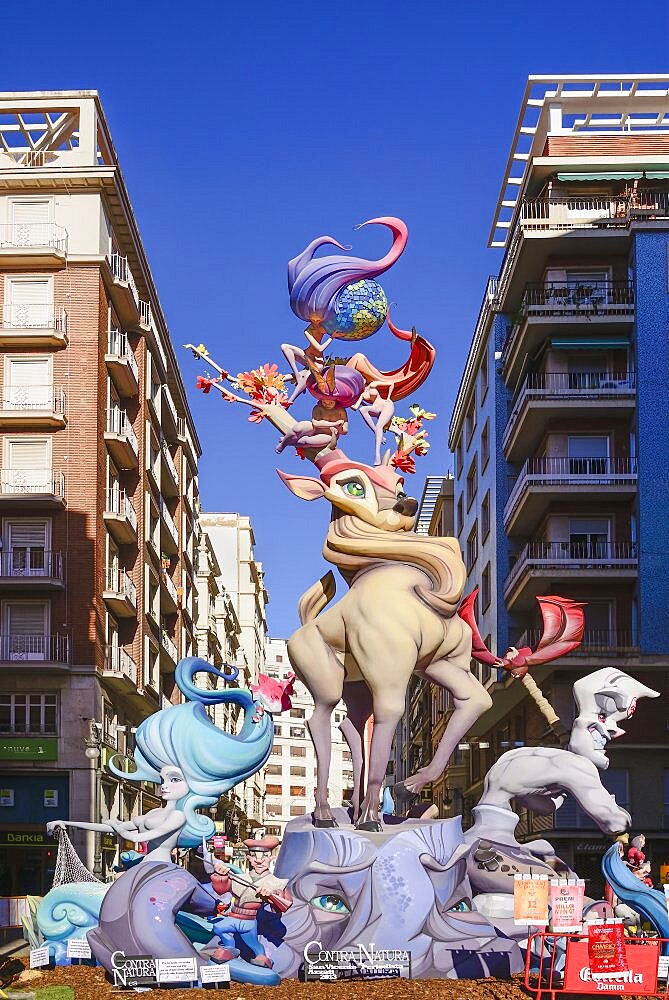 Spain, Valencia Province, Valencia, Typical falla scene with Papier Mache figures in the street during Las Fallas festival.