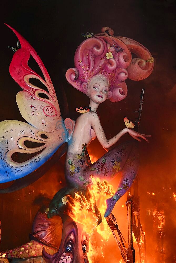 Spain, Valencia Province, Valencia, La Crema, The Burning of the Papier Mache figures in the street during Las Fallas festival on March 19th, fairy figure going up in flames.