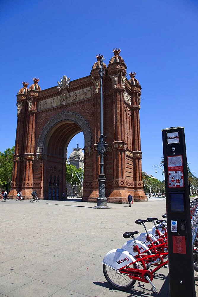 Spain, Catalonia, Barcelona, Parc de la Ciutadella, public hire bicycles next to Arc de Triomf.