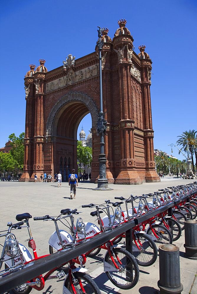 Spain, Catalonia, Barcelona, Parc de la Ciutadella, public hire bicycles next to Arc de Triomf.