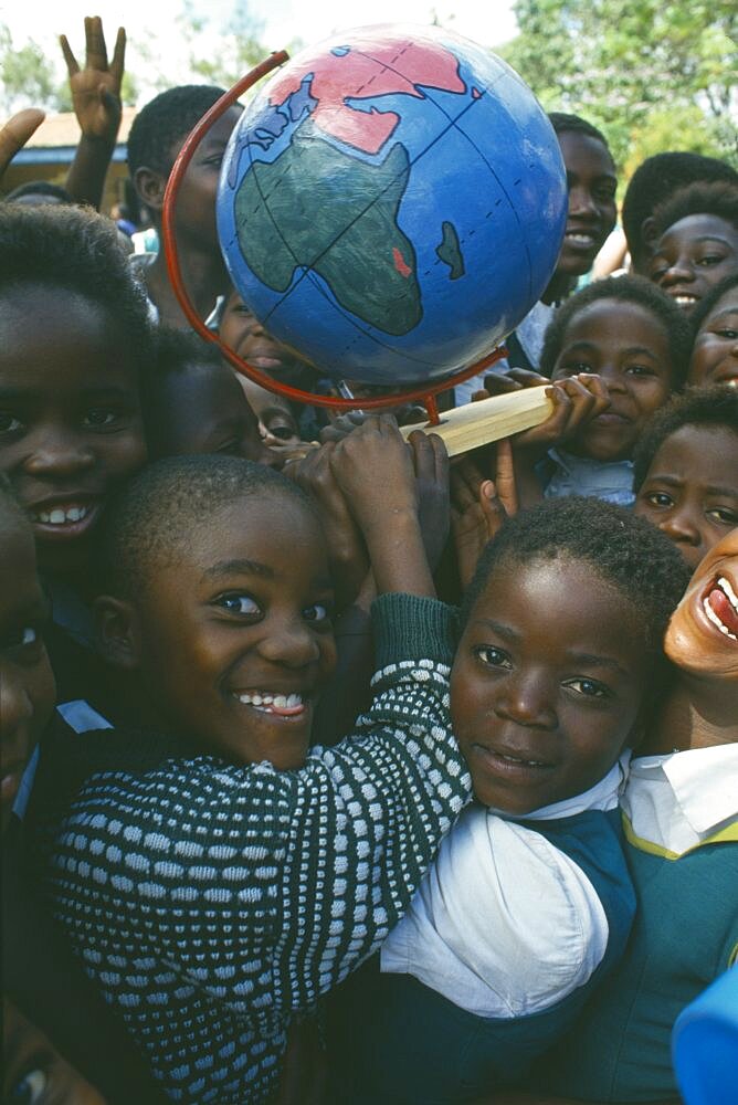 MALAWI  Blantyre School children with globe made by Pamet paper making project which produce fair trade goods from recycling everything from newspaper to elephant dung.