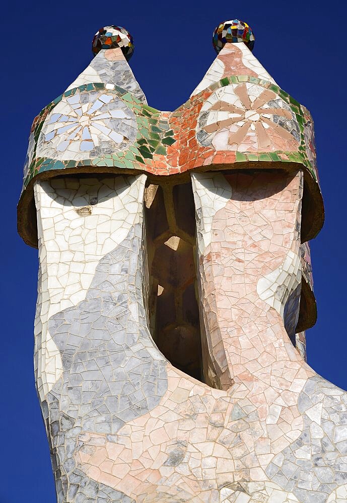 Spain, Catalunya, Barcelona, Antoni Gaudi's Casa Batllo building, colourful chimney pots on the roof terrace.