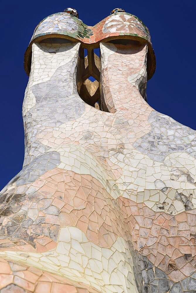 Spain, Catalunya, Barcelona, Antoni Gaudi's Casa Batllo building, colourful chimney pots on the roof terrace.