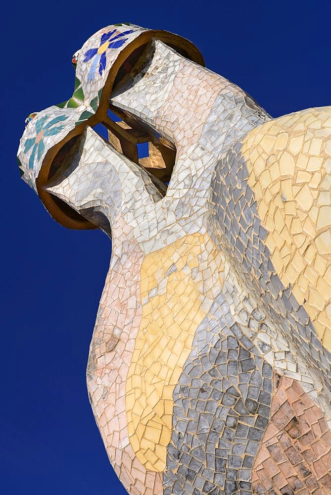 Spain, Catalunya, Barcelona, Antoni Gaudi's Casa Batllo building, colourful chimney pots on the roof terrace.