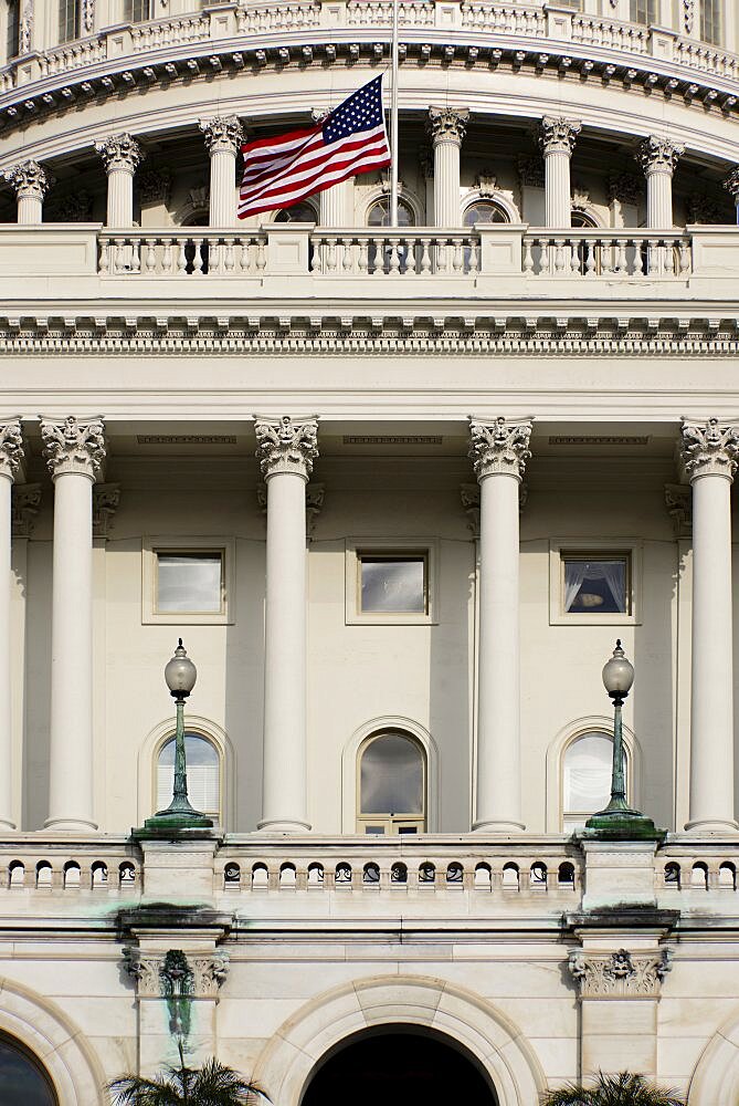 USA, Washington DC, Capitol Building, Section of the building's dome with the American flag at half mast.