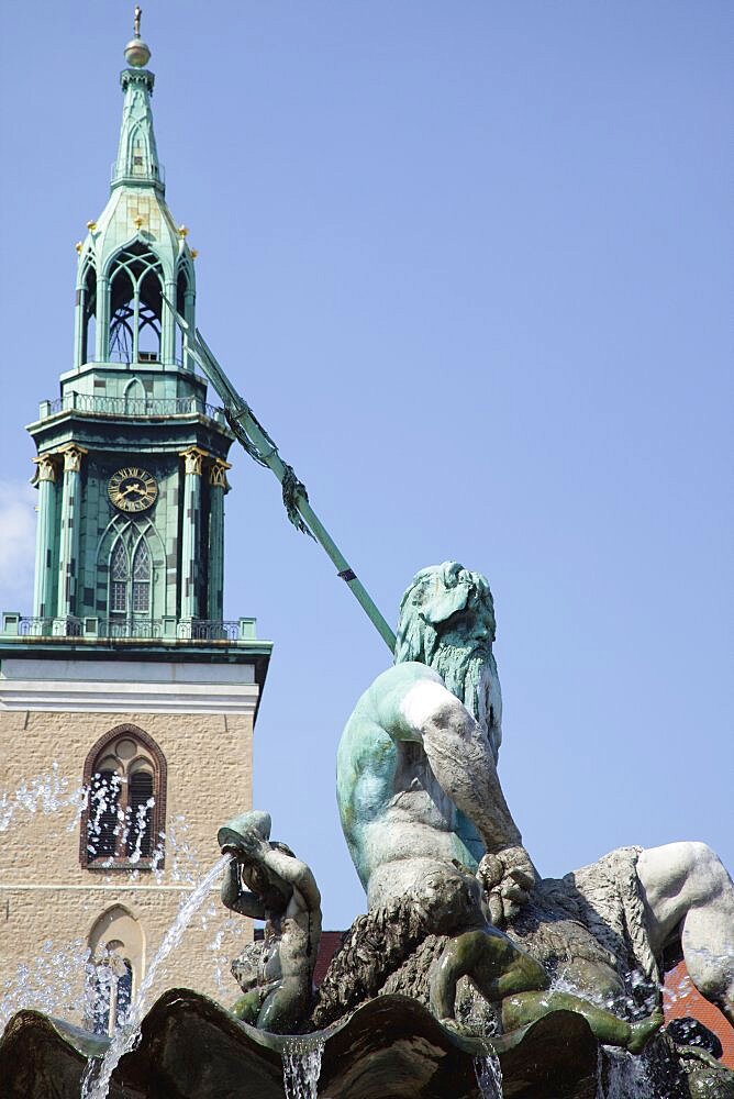 Germany, Berlin, Mitte, Neptunbrunnen fountain next to St Marienkirche in Alexanderplatz.