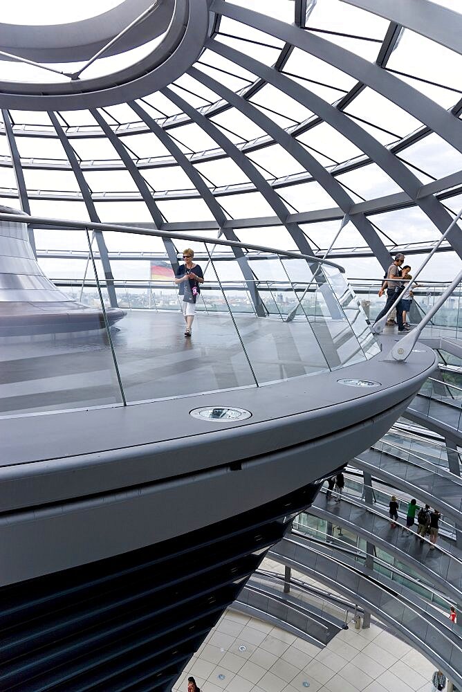 Germany, Berlin, Mitte, Tiergarten, interior of the glass dome on the top of the Reichstag building designed by architect Norman Foster with a double-helix spiral ramp around the mirrored cone that reflect light into the debating chamber of the Bundestag below. The top of the ramp here has the hot air vent from the debating chamber.