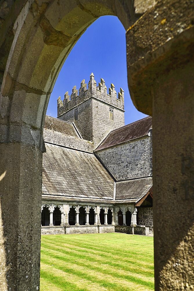 Ireland, County Tipperary, Holycross Abbey, view through an arch of the cloister.