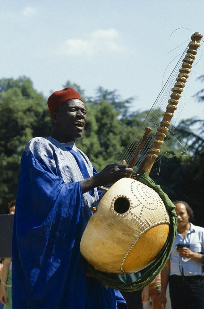 SENEGAL  Music Manoinka musician playing the Kora which is a strung gouro instrument