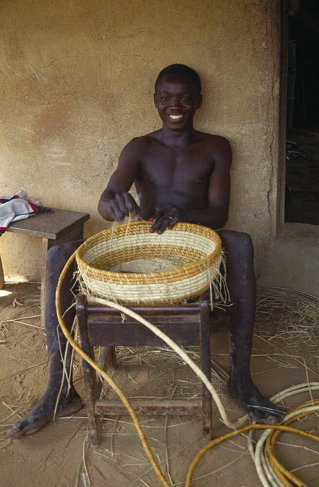 LIBERIA  Upper Lofa Young man making coil basket.