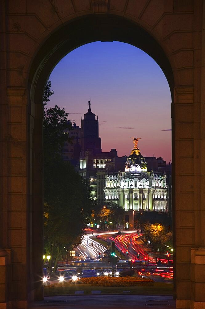 SPAIN  Madrid Night time view along Calle de Alcala towards the Gran Via from the Puerta de Alcala  seen through an arch. Travel Holidays Tourism Road Bridge