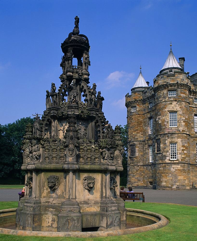 Holyrood Palace part view of western exterior with ornate carved stone fountain in the foreground, Edinburgh, Lothian, Scotland, United Kingdom