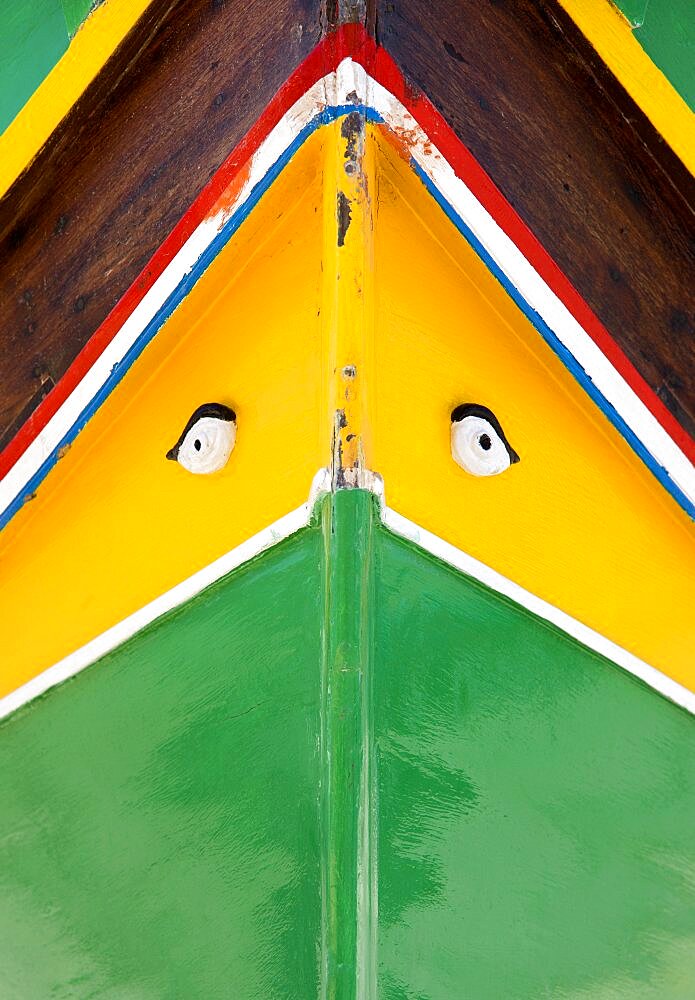 Fishing village harbour on the south coast with colourful Kajjiki fishing boat with the Eyes of Osiris on the bow, Marsaxlokk, Malta
