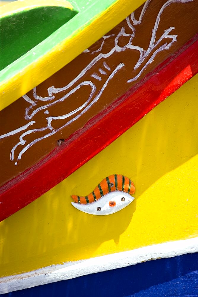 Fishing village harbour on the south coast with colourful Kajjiki fishing boat with the Eyes of Osiris on the bow, Marsaxlokk, Malta