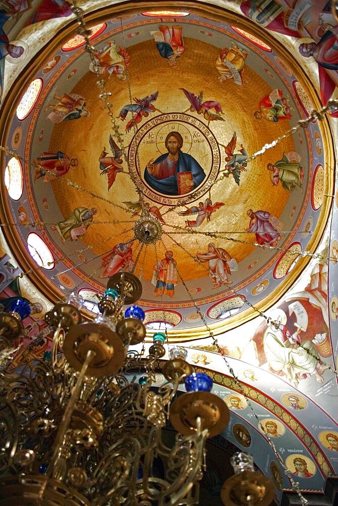 Nazareth, Interior of the Greek Orthodox Church of St, Gabriel also known as the Church of the Annunciation located over the spring that fed Marys Well, Interior of the  dome with painting of Jesus Christ encircled by the Saints with ornate candelabra hanging from centre, Sea of Galilee, Hazafon, Israel