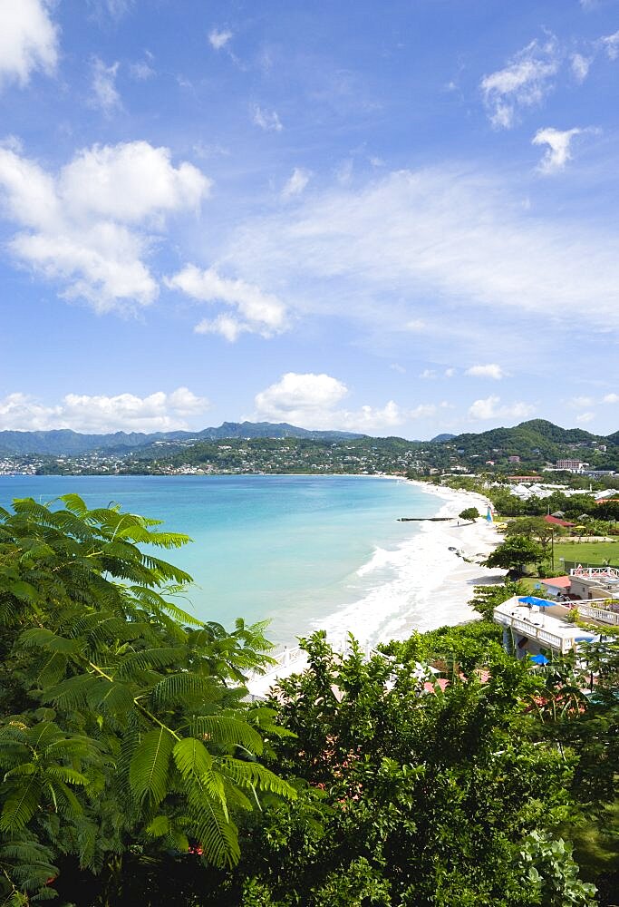 Aquamarine sea and the two mile stretch of the white sand of Grand Anse Beach with St. Georges in the distance, Grenada, West Indies, Caribbean, Central America