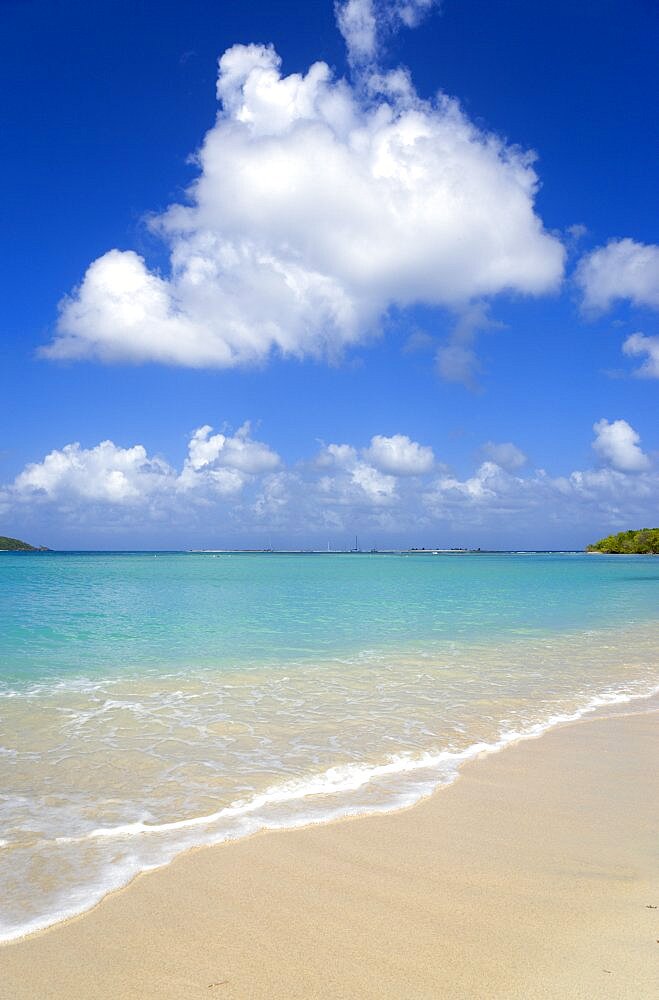 Waves breaking on Paradise Beach at LEsterre Bay with the turqoise sea and Sandy Island sand bar beyond, Grenada