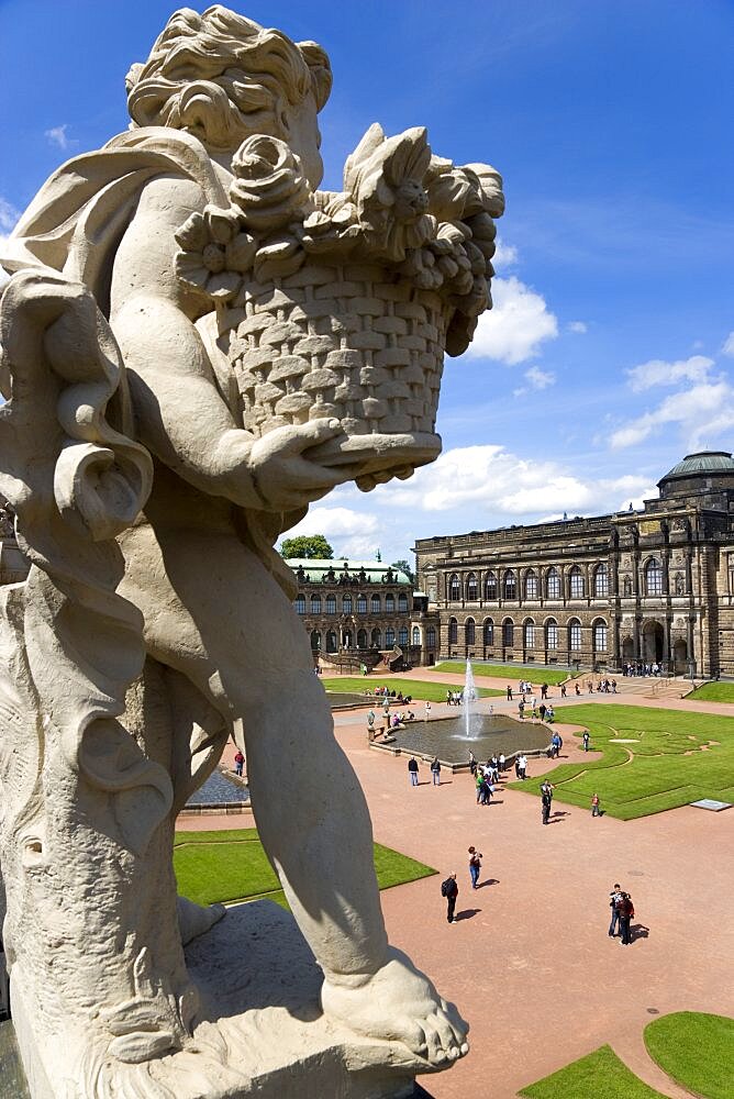 GERMANY, Saxony, Dresden, The central Courtyard and Picture Gallery of the restored Baroque Zwinger Palace gardens busy with tourists seen from the statue lined Rampart originally built between 1710 and 1732 after a design by Matth?us Daniel P?ppelmann in collaboration with sculptor Balthasar Permoser